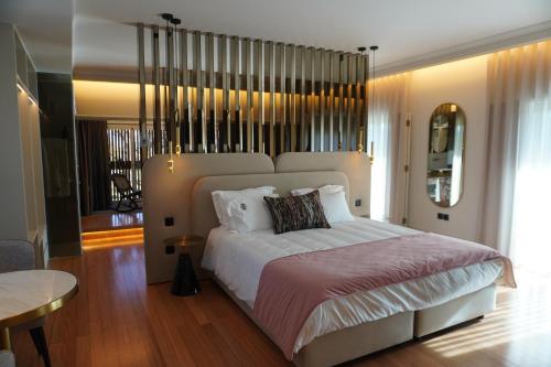 a bedroom with a large bed and a table at Quinta Solar das Fontes in Várzea