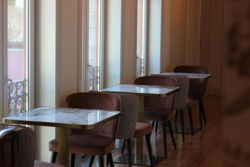 a row of tables and chairs in a restaurant at Quinta Solar das Fontes in Várzea