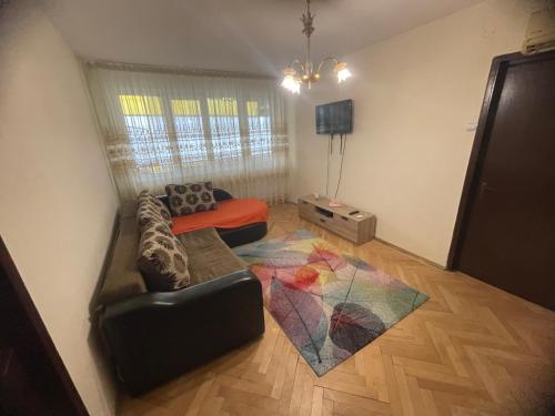 a living room with a couch and a tv at Apartament Eric in Craiova