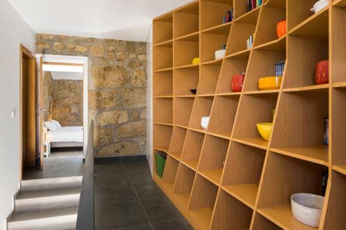 a room with wooden shelves and a hallway at Renoviertes Landhaus Für 4 Personen In Tondela in Tondela