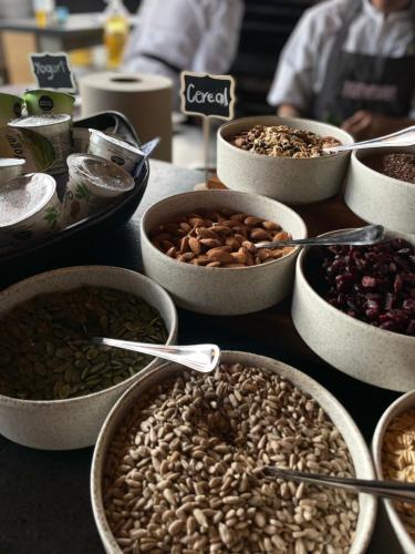 a table topped with bowls of nuts and dried fruits at Hotel Coco in Bogotá