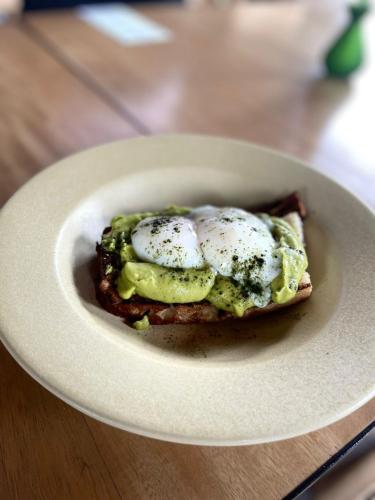 a piece of food with eggs on a white plate at Hotel Coco in Bogotá