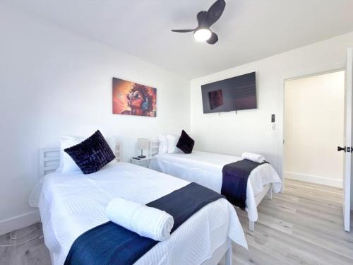 a bedroom with two beds and a ceiling fan at Lux Miami Escape - Near Brickell- Free Parking in Miami