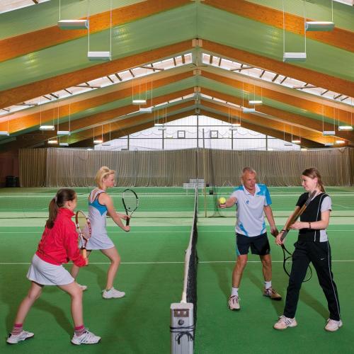 a group of people playing tennis on a tennis court at aktiv Sporthotel Sächsische Schweiz in Pirna