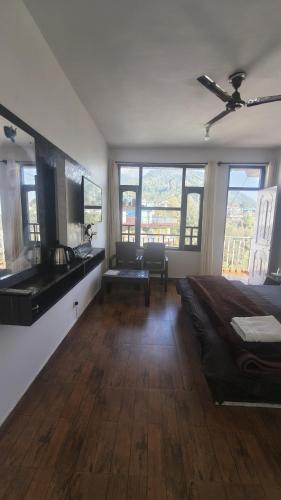 a bedroom with a bed and a desk and a sink at Mcleodganj diaries Guesthouse in Dharamshala