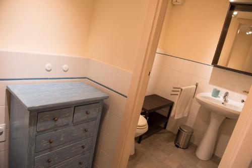 a bathroom with a blue dresser and a sink at Quadrilocale Stella in Alberese