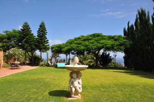 a statue of a teddy bear sitting in the grass at Hacienda in Moya