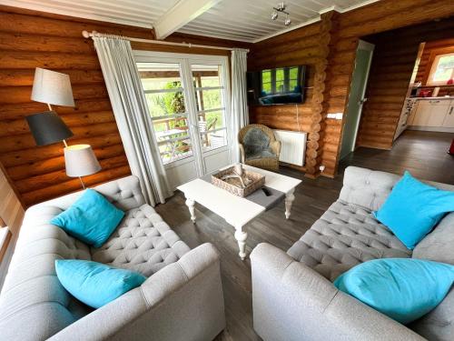 a living room with two couches and a table at villa kunterBUNT in Grödersby