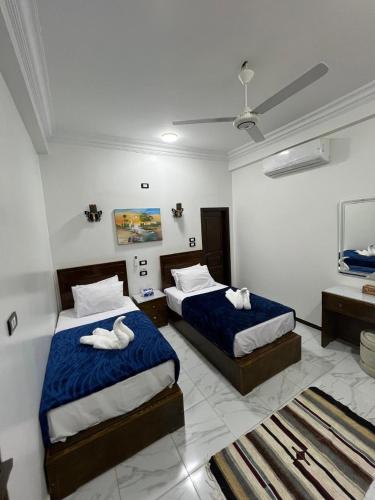 a bedroom with two beds with towels on them at Sama Stars Hotel in Abu Simbel