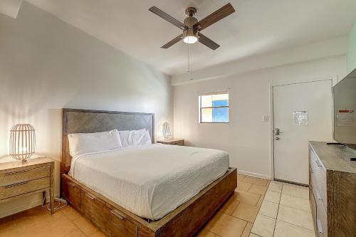 a bedroom with a bed and a ceiling fan at Ocean Waves in Port Aransas