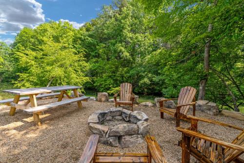 a picnic table and two chairs and a fire pit at Riverfront Fishing, Firepit, Only 4 Miles to the Speedway in Bluff City