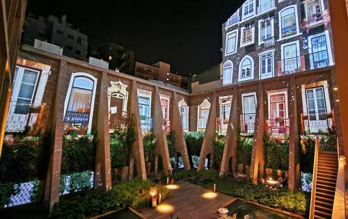 a building with a bunch of umbrellas in a courtyard at Lumen Hotel & The Lisbon Light Show in Lisbon