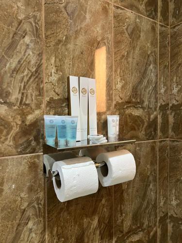 a bathroom with two rolls of toilet paper on a wall at سويت غرفتين وصالة مميز in Jeddah