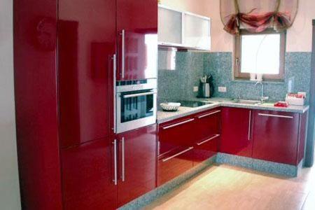 a kitchen with red cabinets and a red refrigerator at Casa Alhambra 4 6 P in Guía de Isora