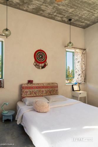 a bedroom with a large bed in a room at הבית האנדלוסי in H̱aẕeva