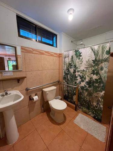a bathroom with a toilet and a sink at Point Break Santa Teresa in Santa Teresa Beach