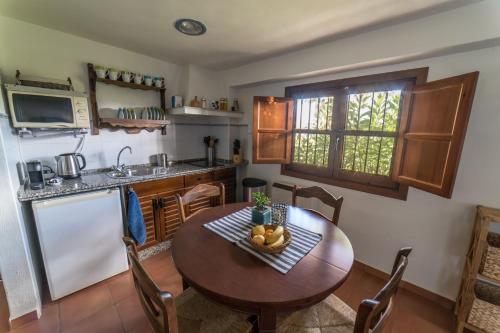 a kitchen with a table with a bowl of fruit on it at Casa El Pino Azul, Ferienhaus Für 2 4 Personen in Dúrcal