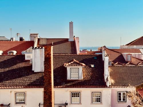 a view of roofs of buildings in a city at Friendly Hills Bairro Alto in Lisbon