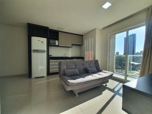 ein Wohnzimmer mit Couch und Küche in der Unterkunft Residencial Dinapoli in Foz do Iguaçu