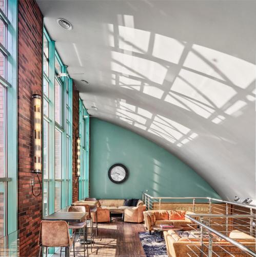 a room with chairs and a clock on the wall at ABION Spreebogen Waterside Hotel Berlin in Berlin