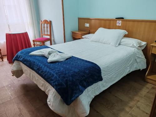 Postel nebo postele na pokoji v ubytování Hostal Ponte Dos Santos