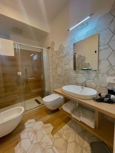 a bathroom with a sink and a toilet and a shower at Domus Fontana in Pompei