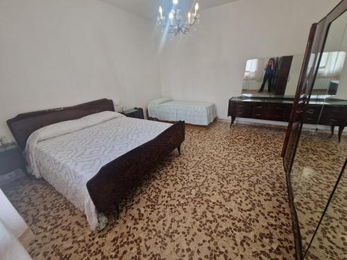 a bedroom with a bed and a mirror and a dresser at CasaMiria in Seravezza
