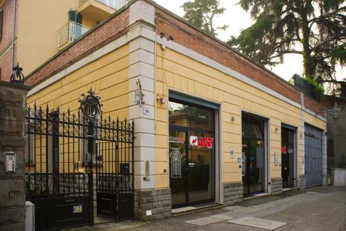 a yellow building with a gate on a street at Residence Porta Saragozza in Bologna