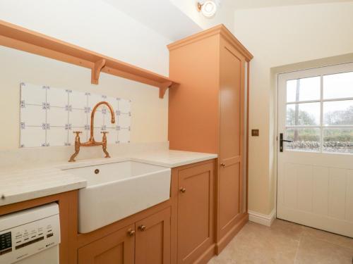 a kitchen with a sink and a window at Velindra Farm Cottage in Hereford
