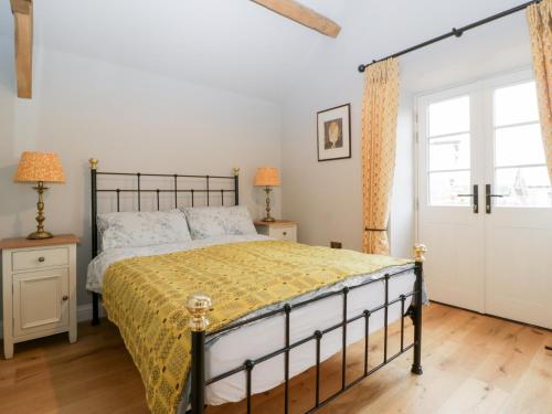 a bedroom with a bed and a window at Velindra Farm Cottage in Hereford