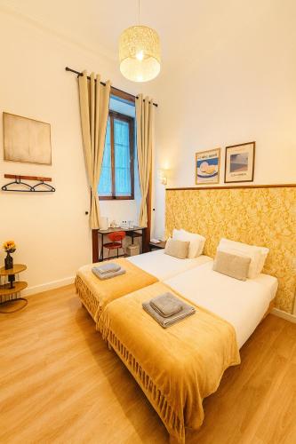 a bedroom with two beds and a large window at Happy Holiday Sintra in Sintra
