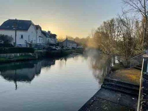 a view of a river with houses and buildings at 2-room apartment near Marais and CV in Bourges