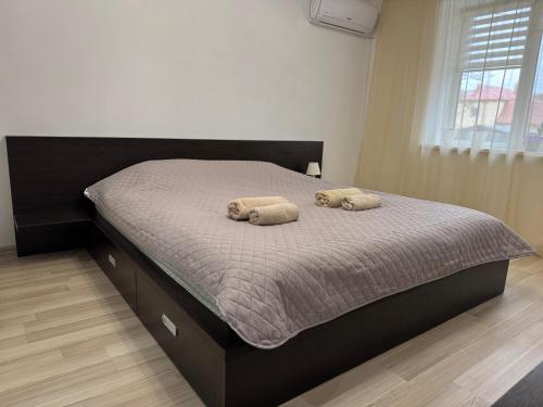 a bedroom with a bed with two towels on it at Veronika Apartments in Berehove