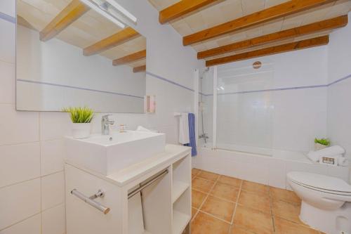 a bathroom with a white sink and a toilet at Villa Marilen in Alcudia