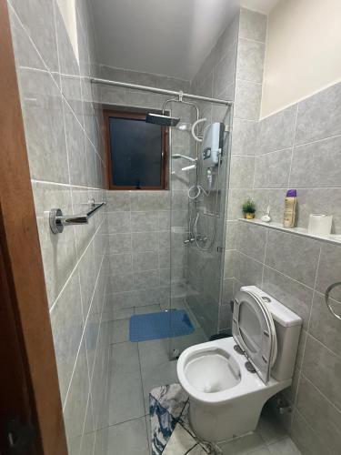 a bathroom with a shower with a toilet and a shower at LionsGate Homes in Nakuru