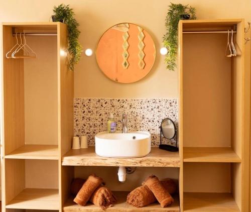 a bathroom with a sink and a mirror at Cosy Cloître, appartement authentique centre Arles in Arles