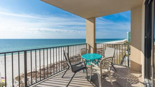 un balcon avec une table et des chaises et l'océan dans l'établissement Phoenix X 711 condo, à Orange Beach