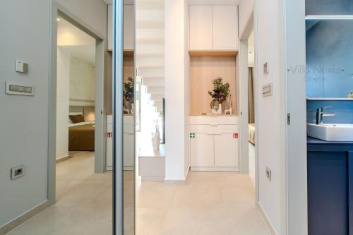 a hallway with a sink and a bathroom at Villa Nexia Šibenik in Šibenik