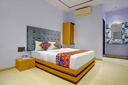 a bedroom with a large bed in a room at Nidhivan Palace in Surat