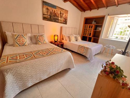 a bedroom with two beds and a window at Casa La Morada in Medellín