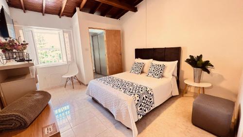 a bedroom with a bed with pillows on it at Casa La Morada in Medellín