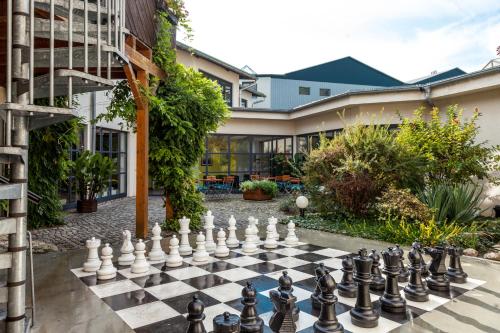 a chessboard in the courtyard of a building at aktiv Sporthotel Sächsische Schweiz in Pirna