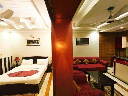 a hotel room with a bed and a couch at Triple One Premier in Abbottabad
