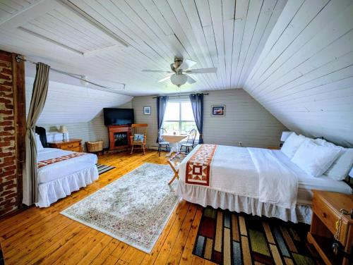 a bedroom with a large bed and a ceiling at Applewood Inn Bed and Breakfast in Twillingate