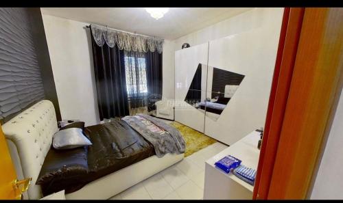 a living room with a leather couch and a mirror at private room in Seveso