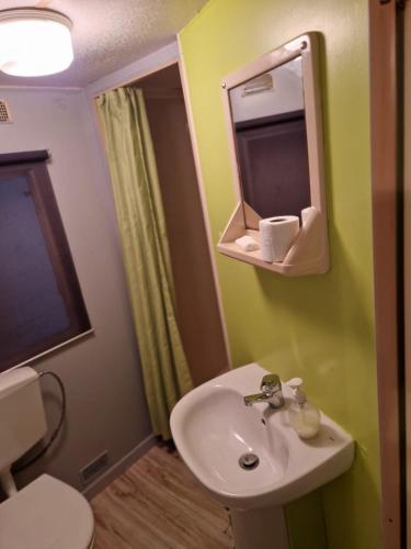 a bathroom with a sink and a mirror at Green Coast Lodge in Vila Nova de Milfontes