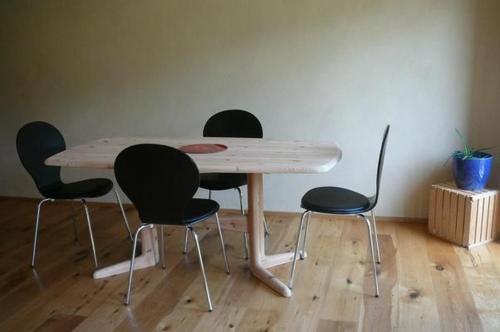 a wooden table with four chairs in a room at Hof Quadra in Flerden