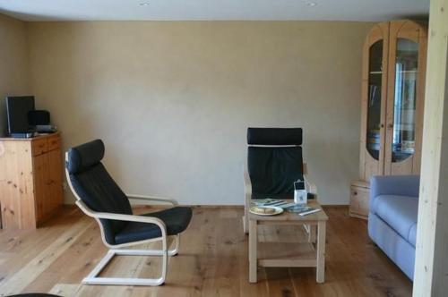 a living room with a couch and a chair and a table at Hof Quadra in Flerden