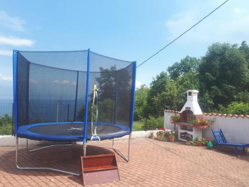 - un trampoline bleu sur une terrasse en briques dans l'établissement Gemütliche Ferienwohnung Mit Toller Aussicht, à Dobreć