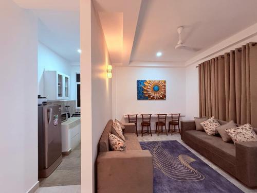 a living room and kitchen with a couch and a table at Blooming Residences by Gold Mark Property Consultants in Nugegoda